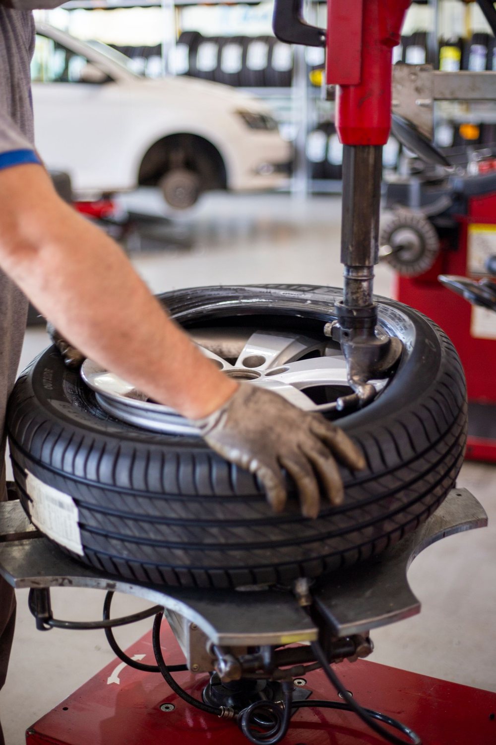 Licensed stock photograph: a tire being worked on a mounting machine.